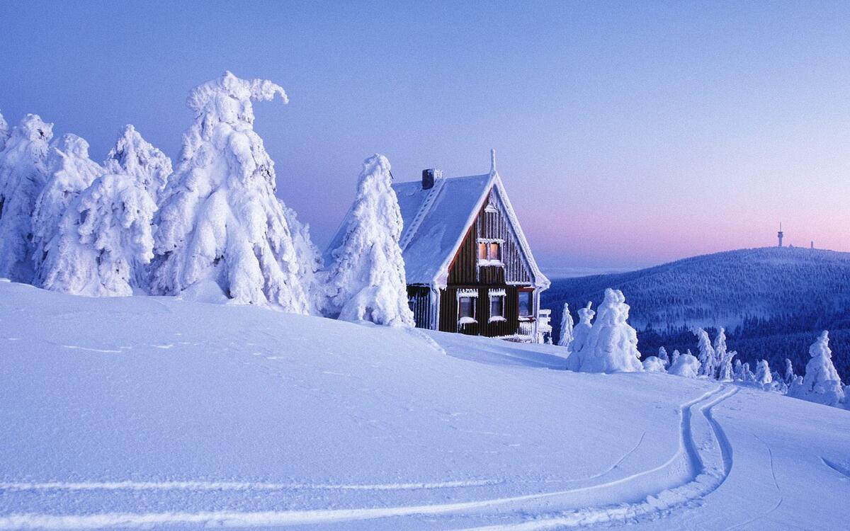 A wooden house on a snowy slope