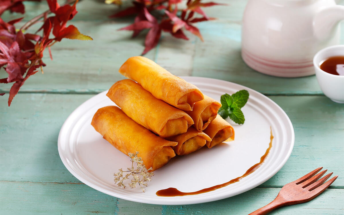 Delicious fried pancake rolls on a white plate