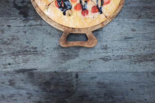 A picture of a delicious berry pie on a wooden board