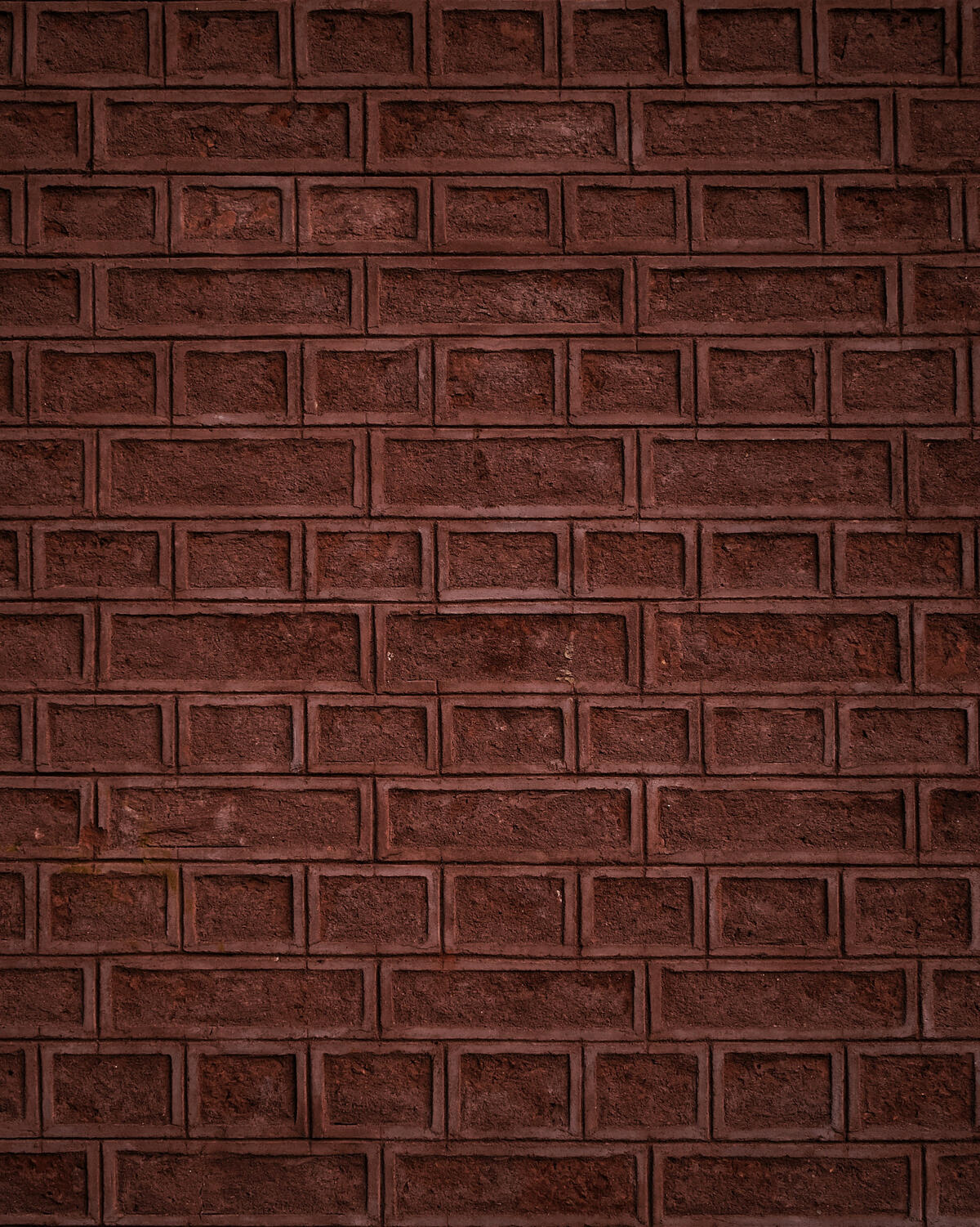 The brick wall is red in color