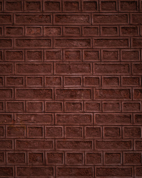 The brick wall is red in color