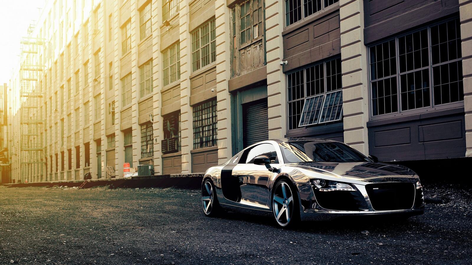 Free photo Chromed Audi R8 stands outside an old house