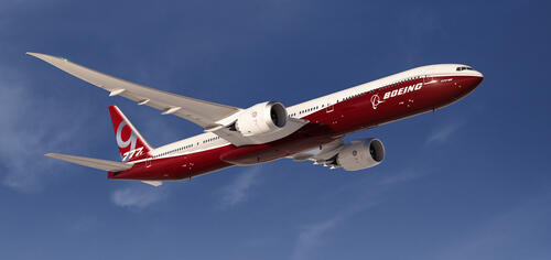 A red-and-white Boeing against the sky.