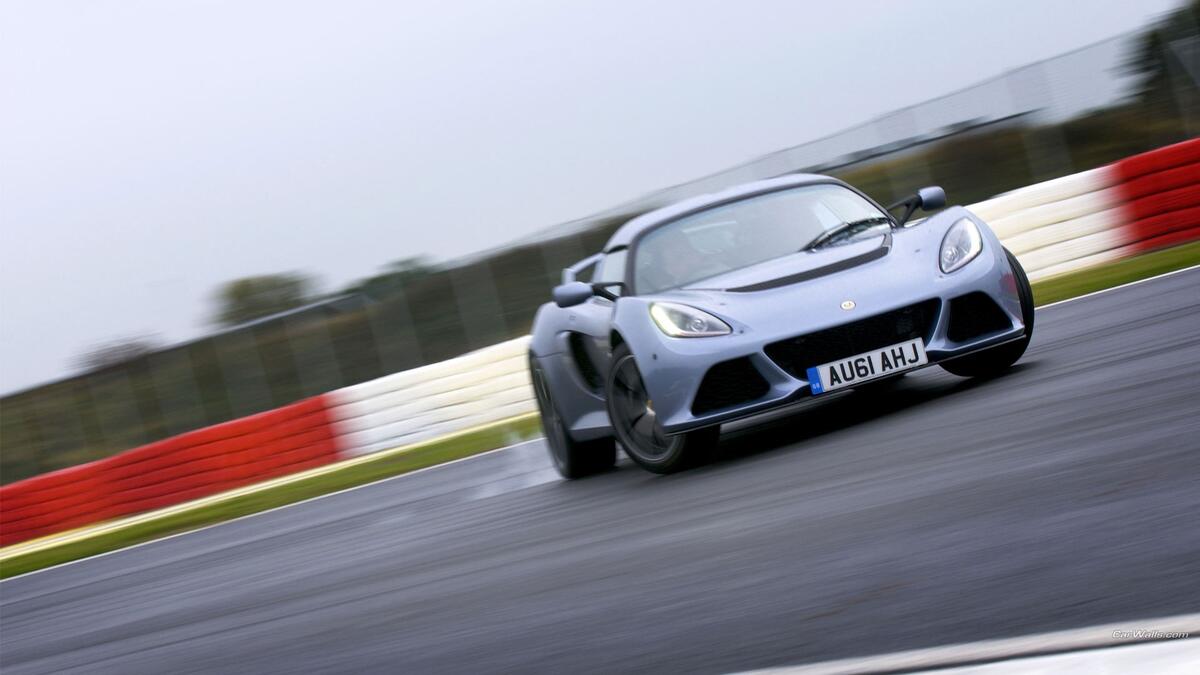 Lotus Exige racing on a sports track.