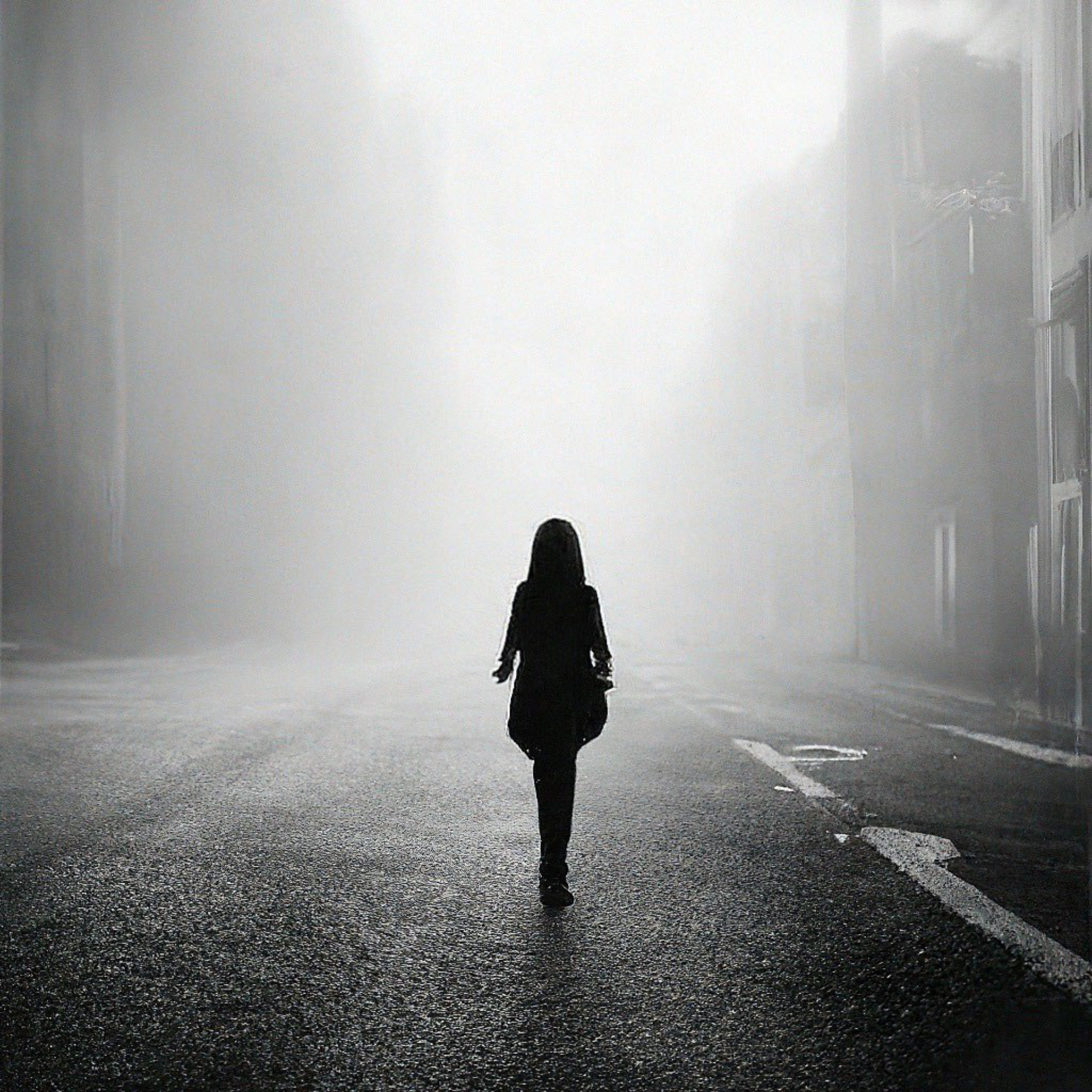A girl walking down a dark street