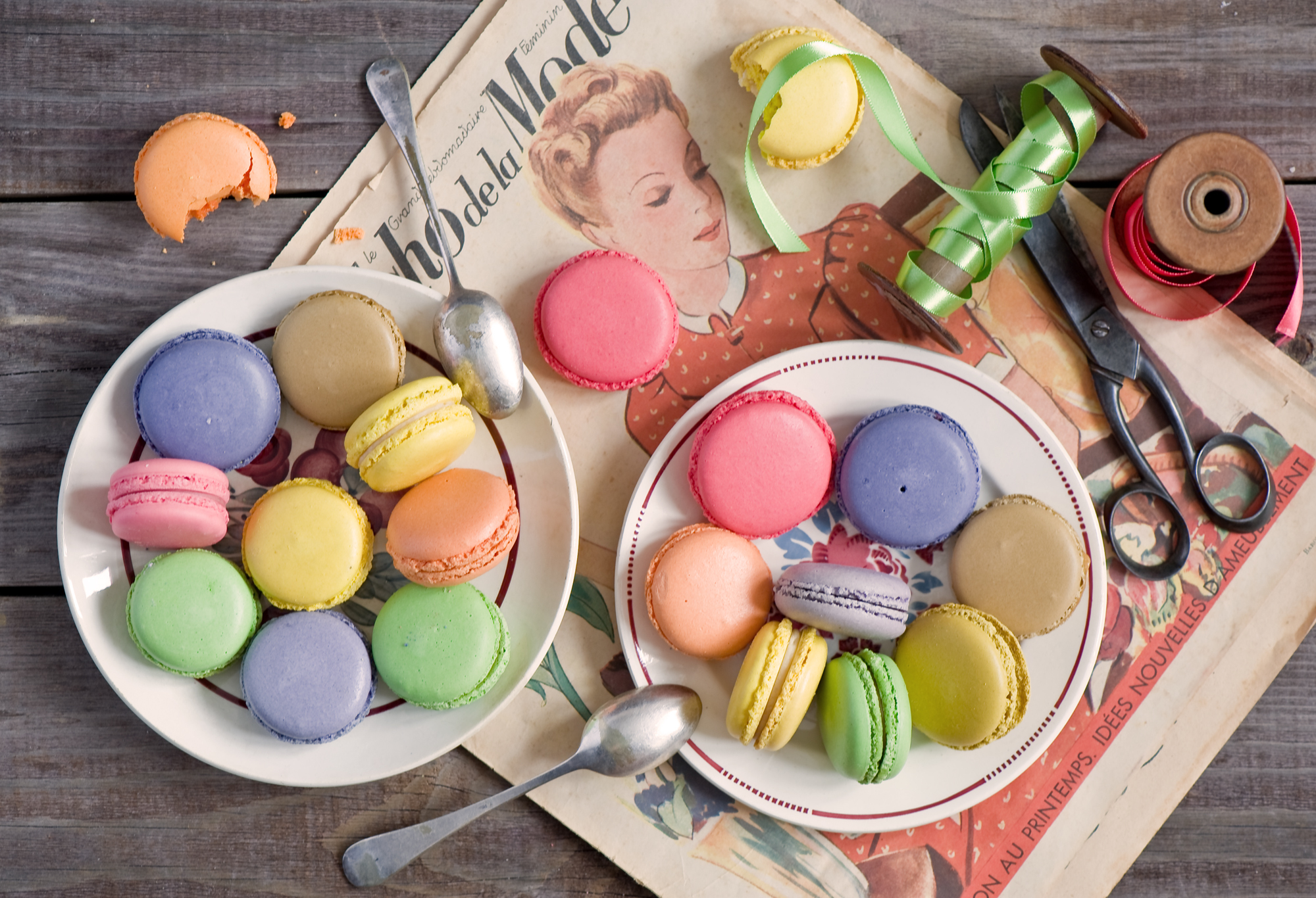 Two plates of colored macarons