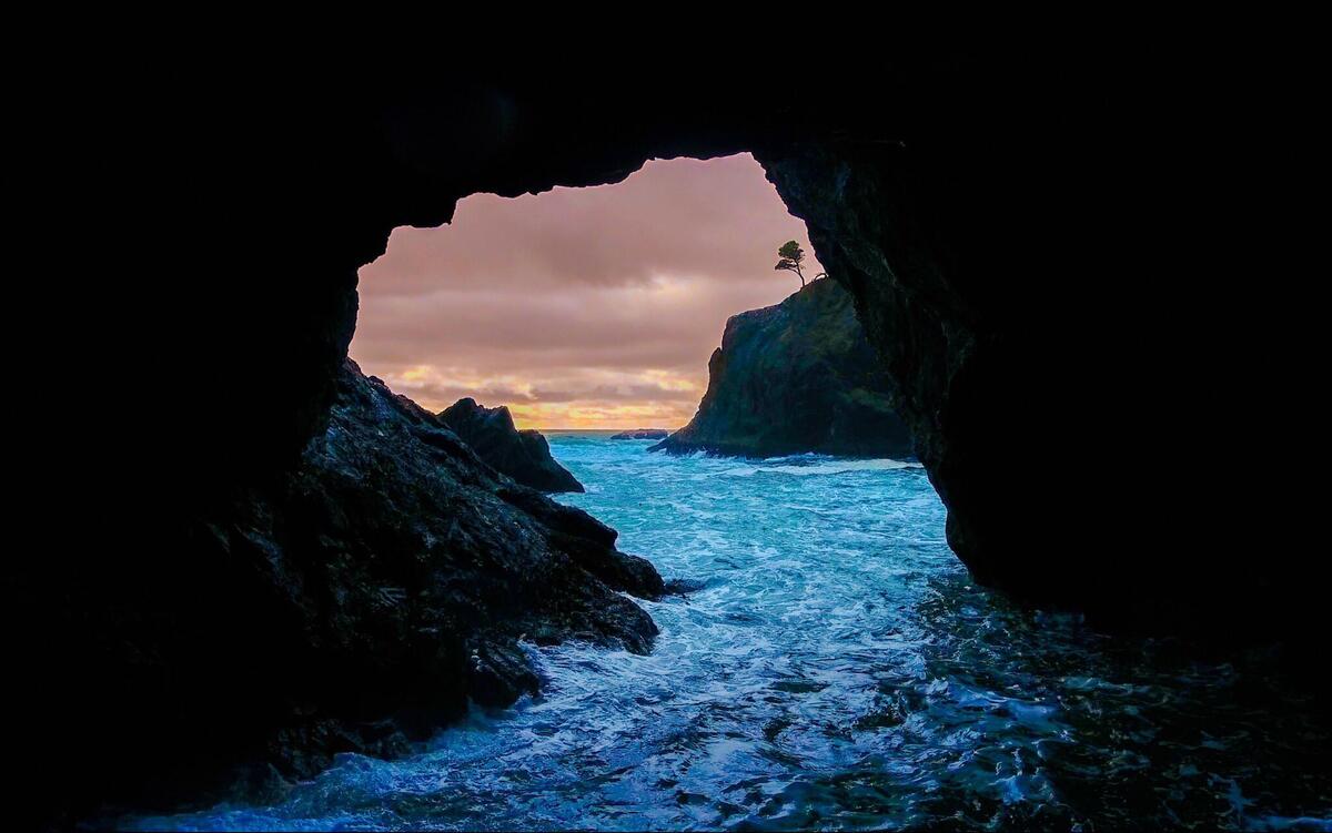 Sea strait in the cave at sunset