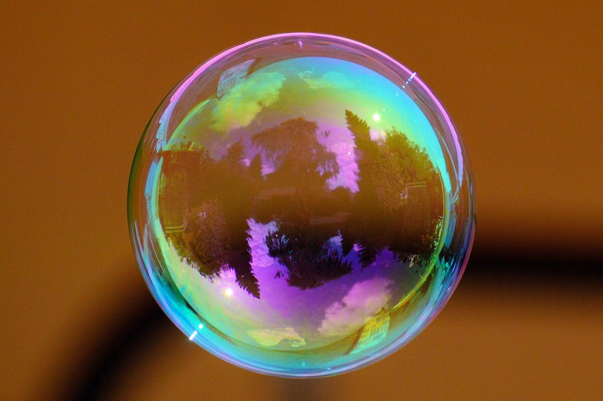 The soap bubble shimmers with multicolored colors