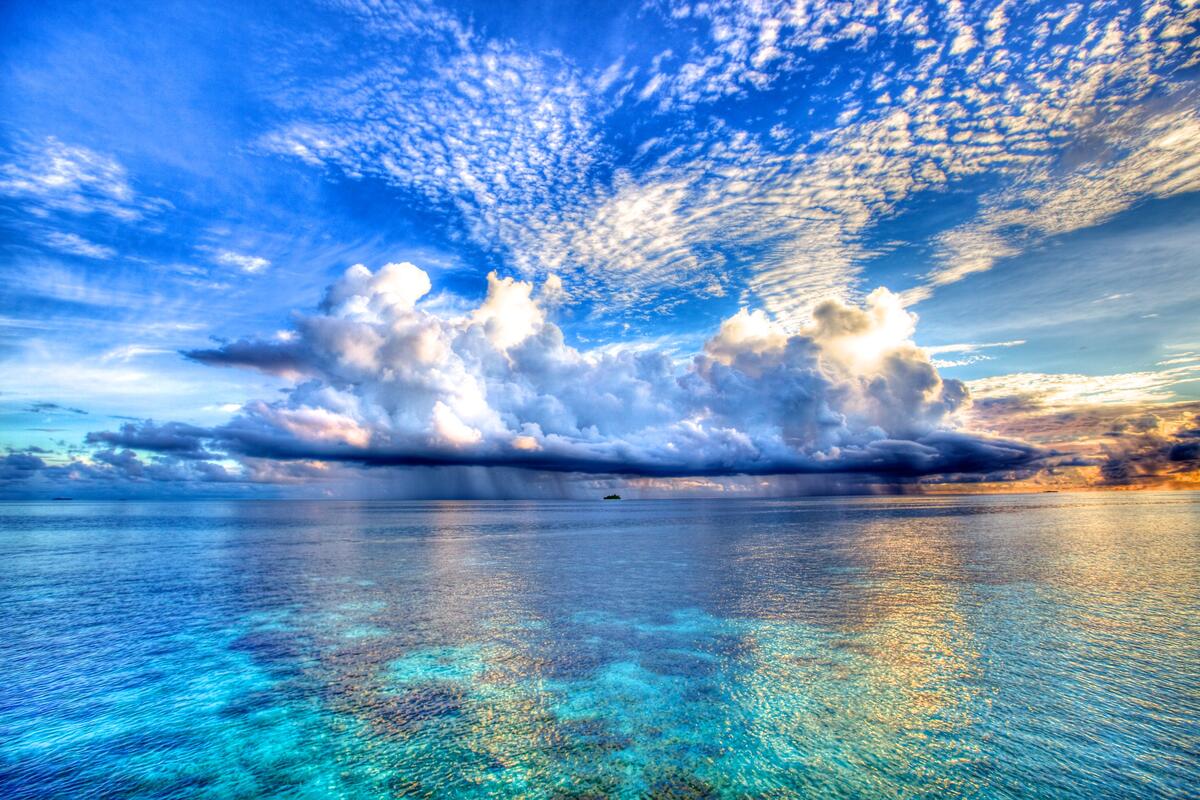 Cloudy sky over the blue sea
