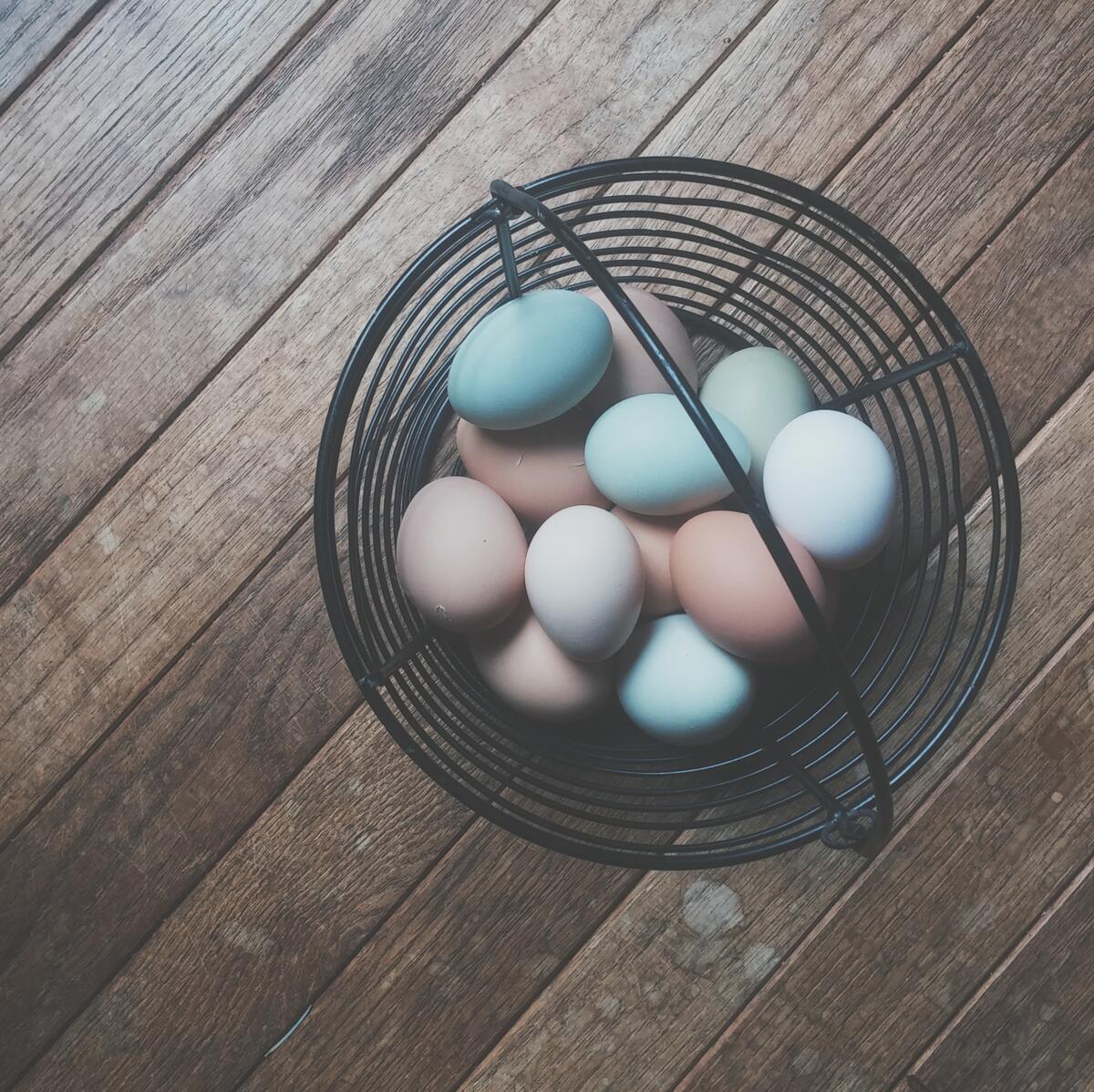 Colored eggs in a big basket