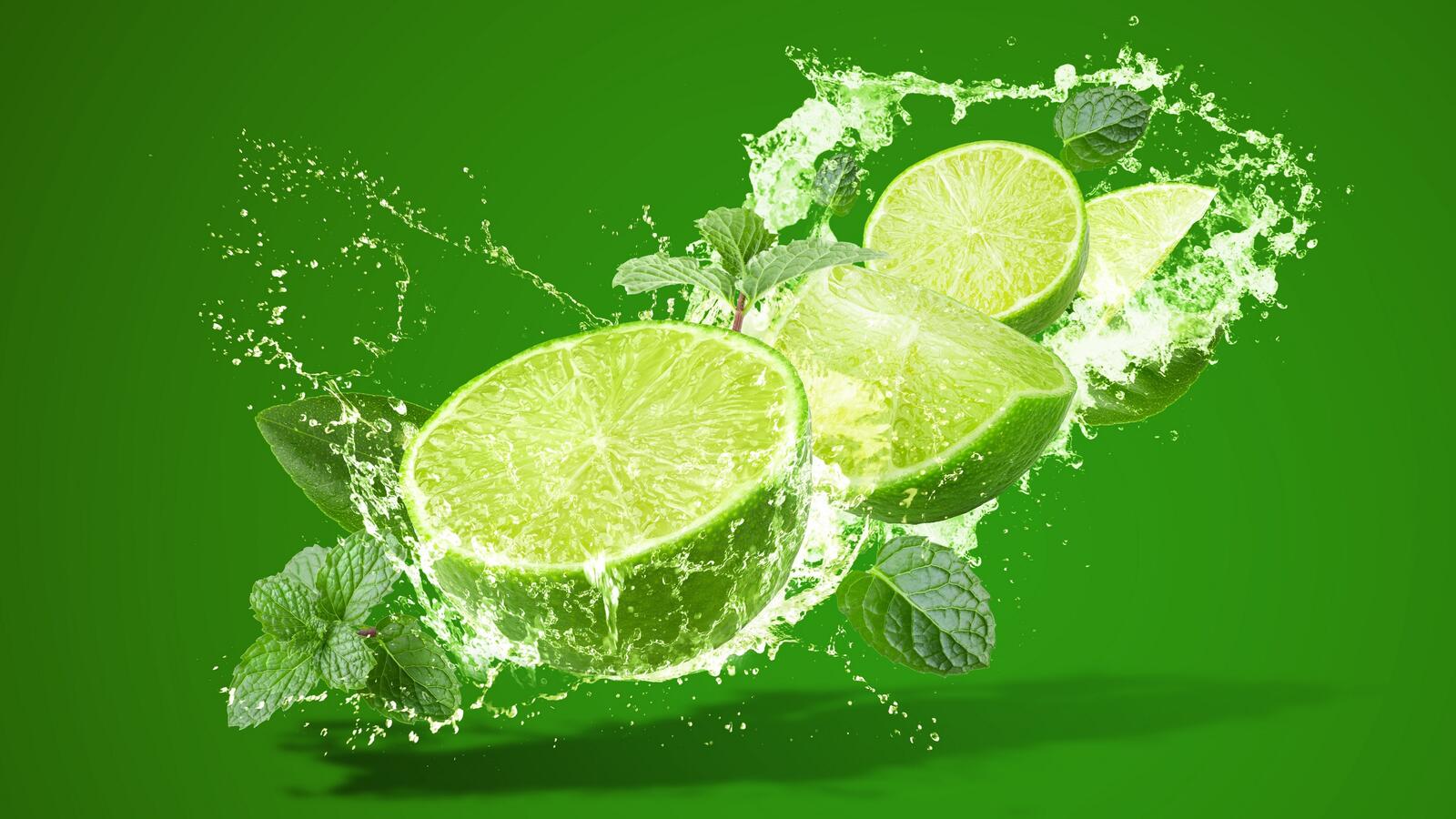 Free photo Lime slices on a green background