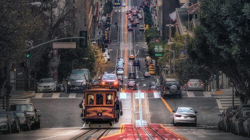 A streetcar runs through the streets of San Francisco