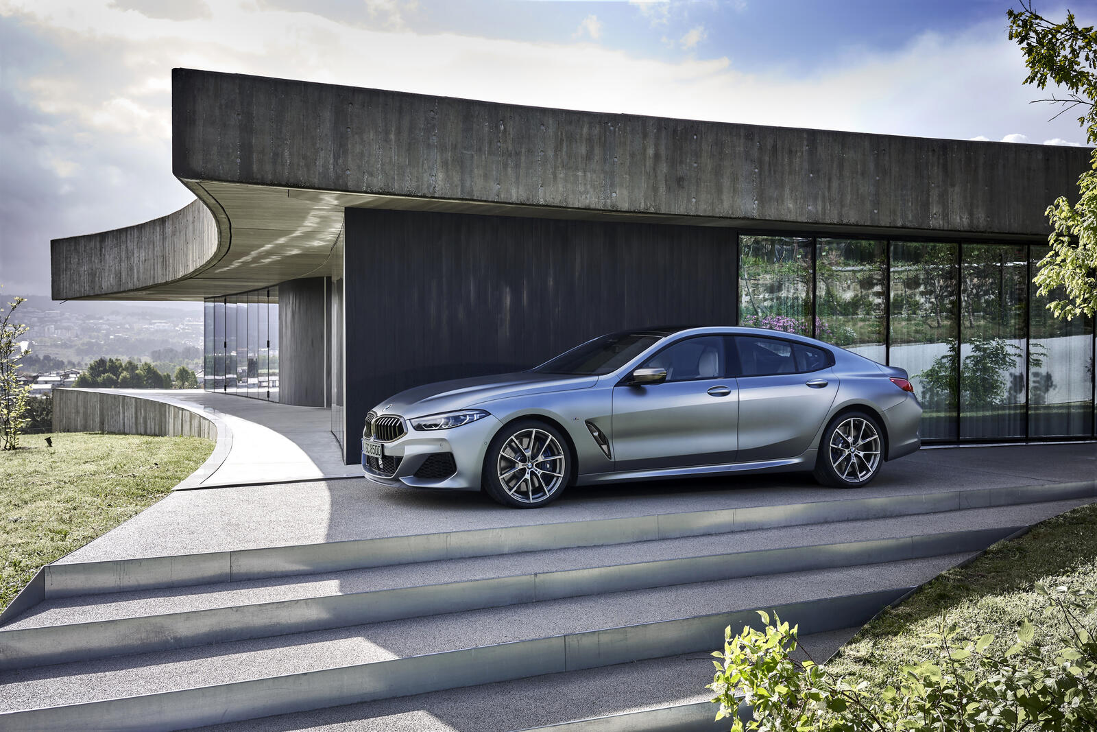 Free photo Bmw 8 Series Gran Coupe in matte gray standing outside its own villa