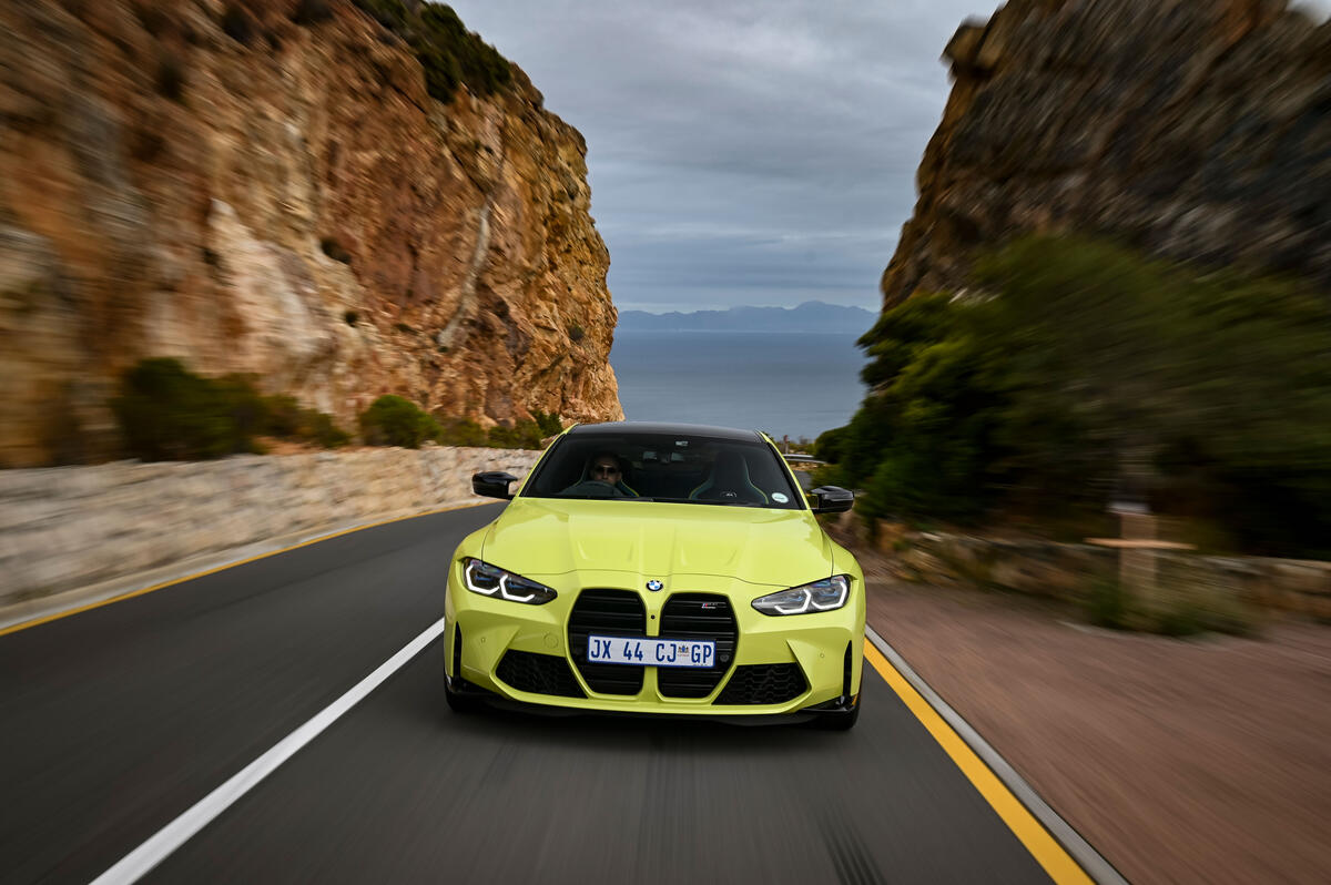 A pale yellow 2021 BMW M4 with right-hand drive