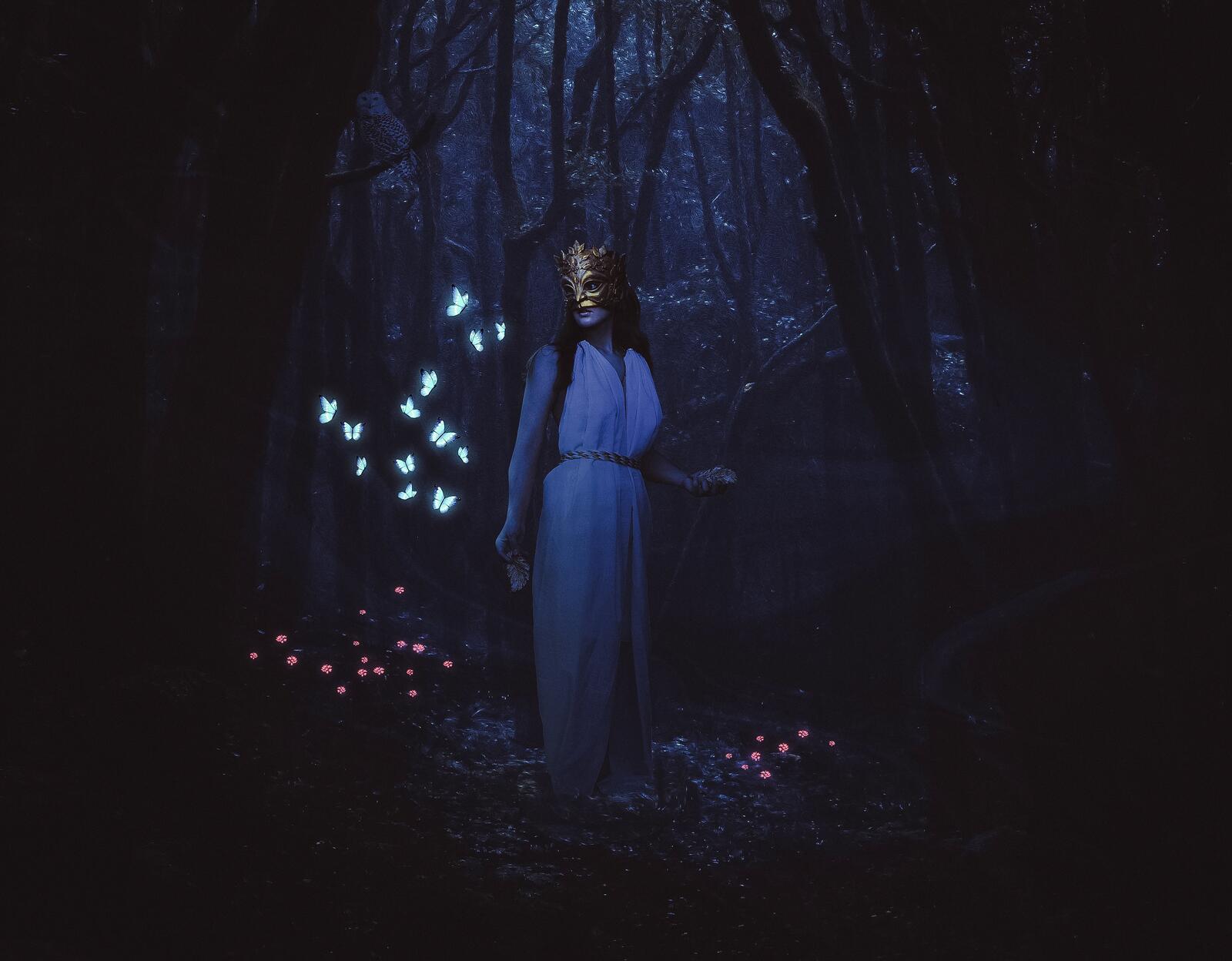 Бесплатное фото Девушка в маске в тёмном лесу