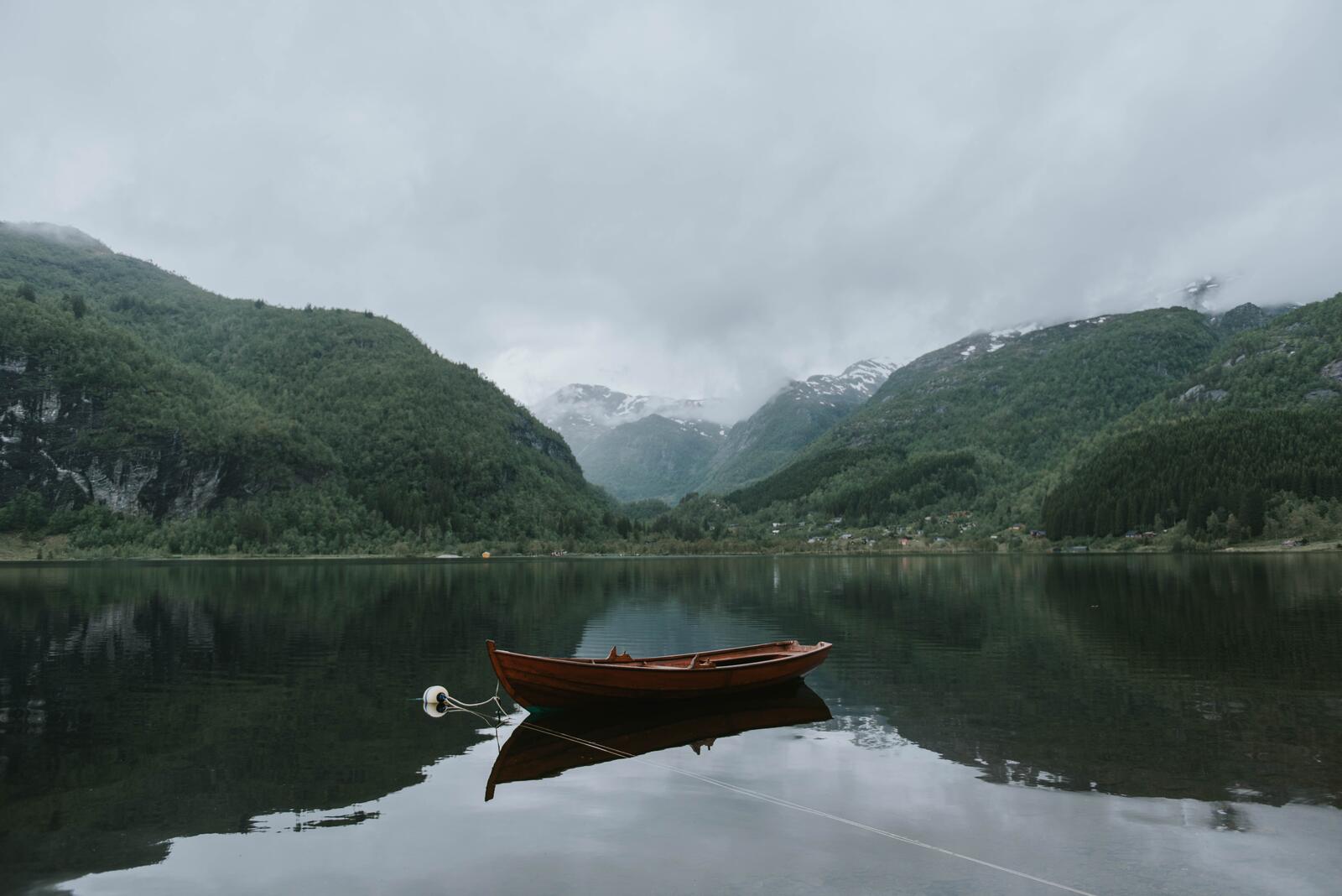 免费照片湖面上一艘孤独木船的照片