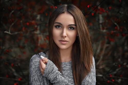 Brunette with long hair in a gray sweater