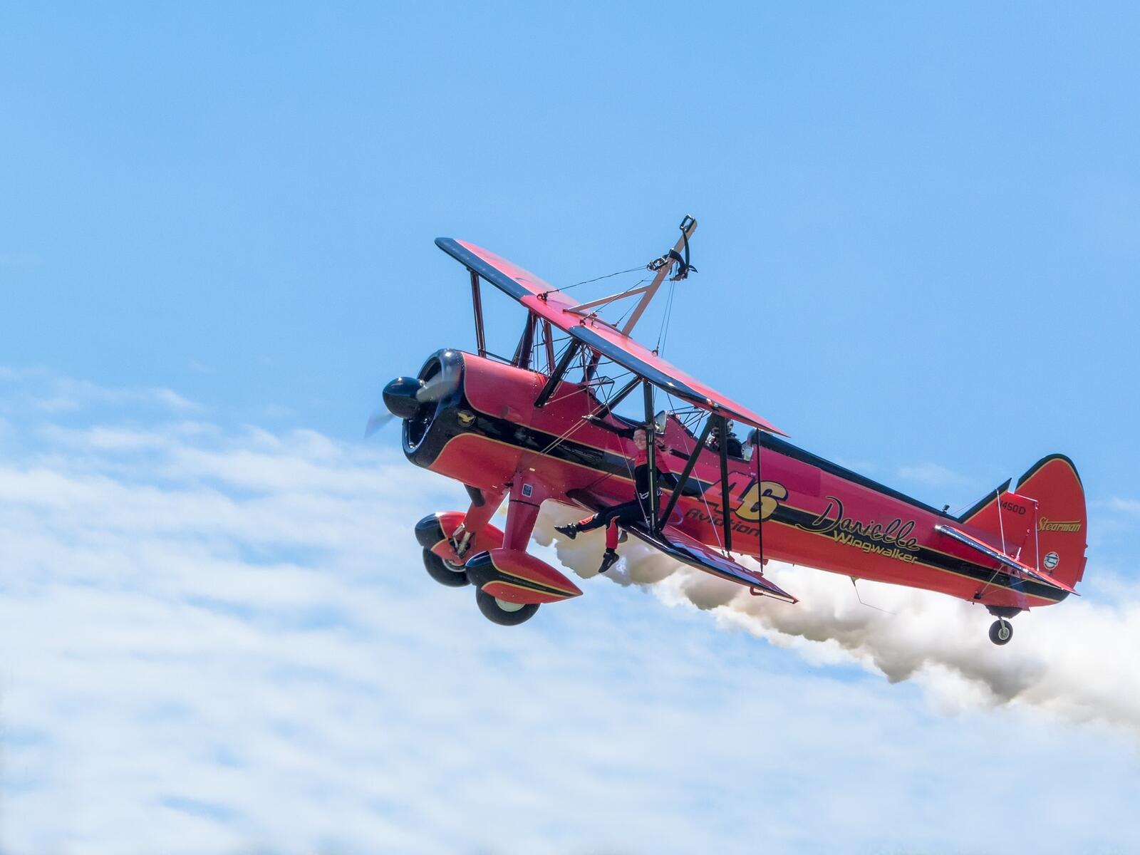 Free photo A red biplane in the sky