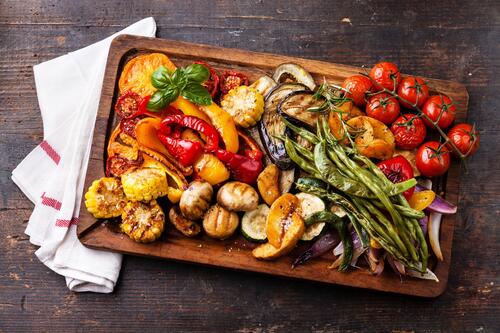Baked vegetables on a wooden tray