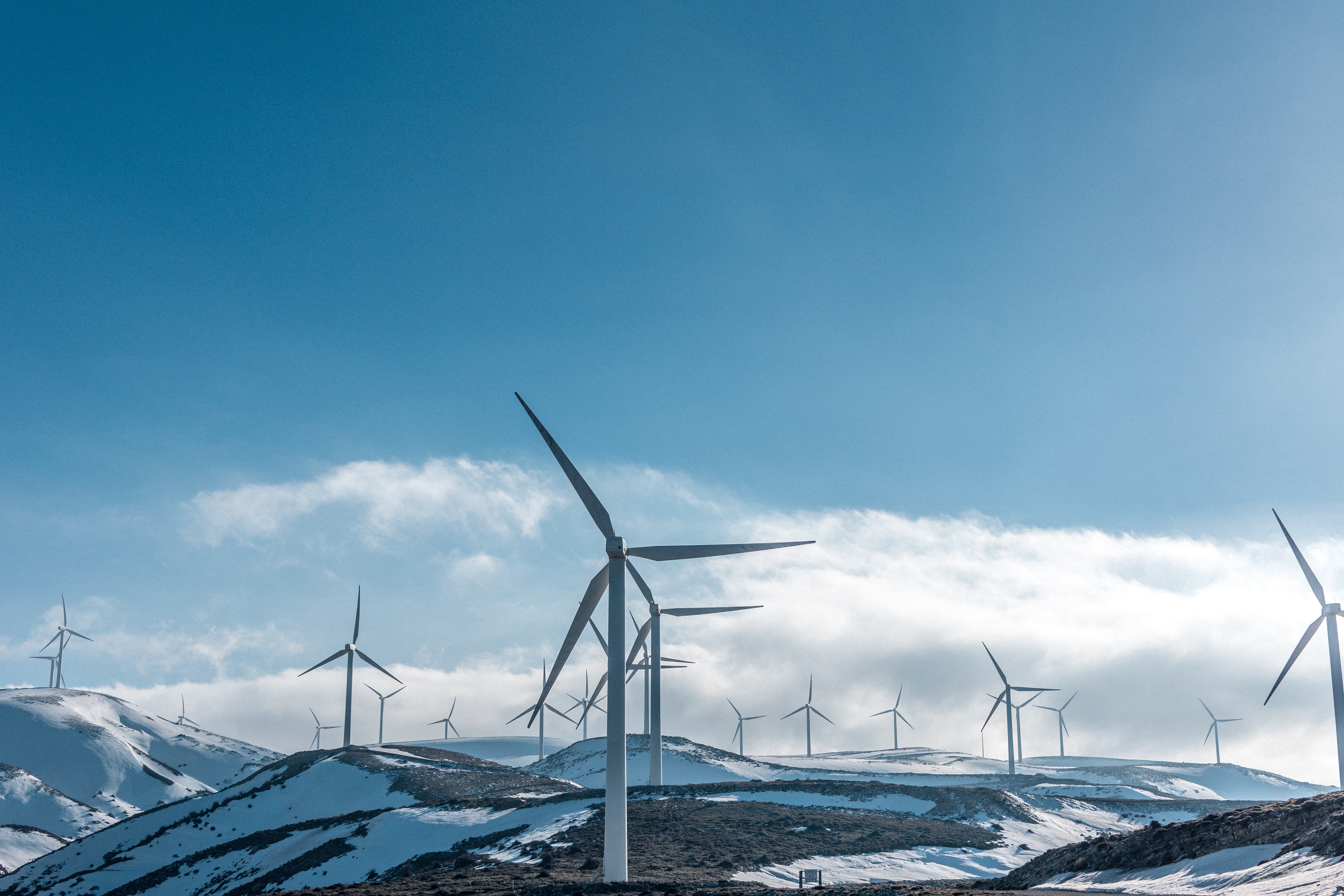 Free photo Windmills on mountain tops in winter