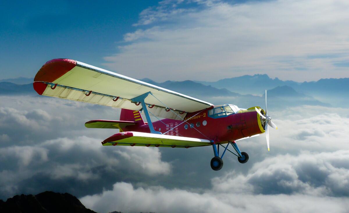 A light aircraft above the clouds