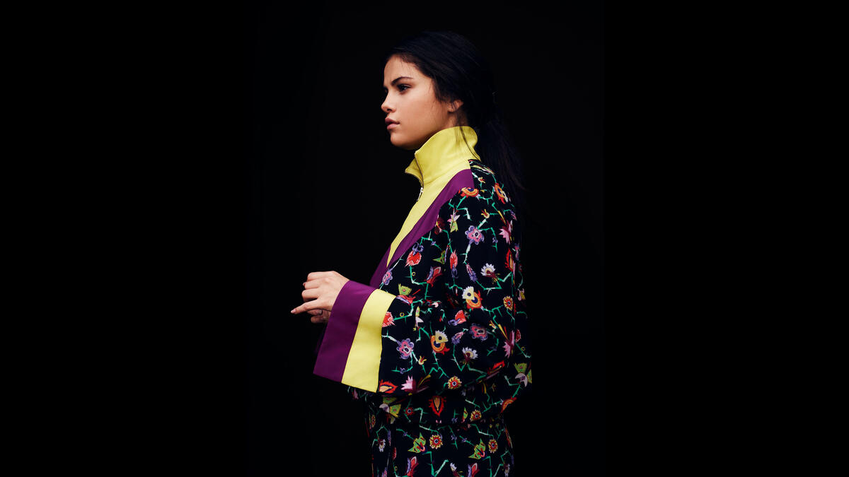 Selena Gomez in a kimono against a black background