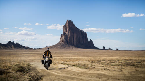 Motorcyclist rides through the desert