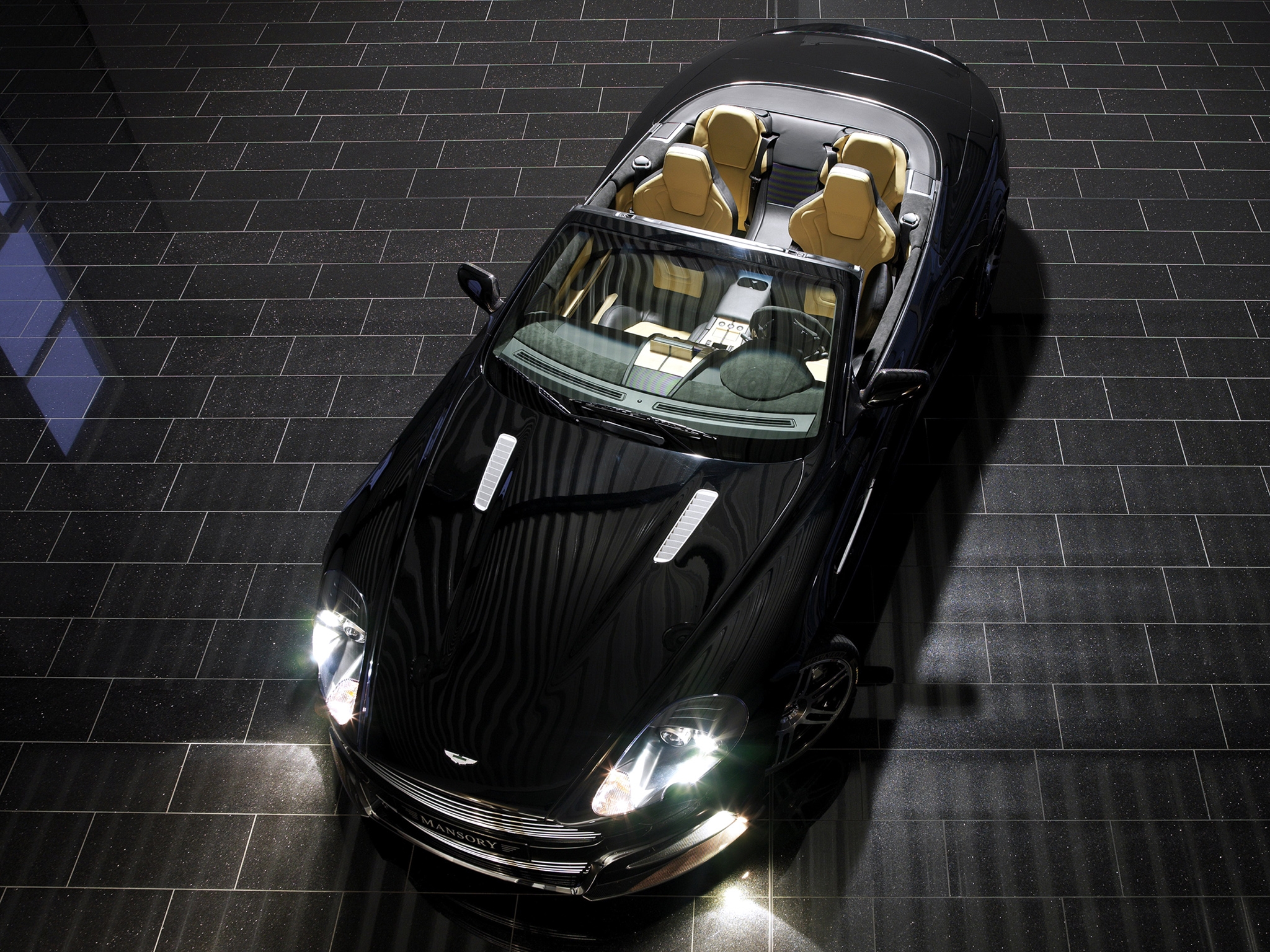 Free photo Aston Martin with the headlights on.