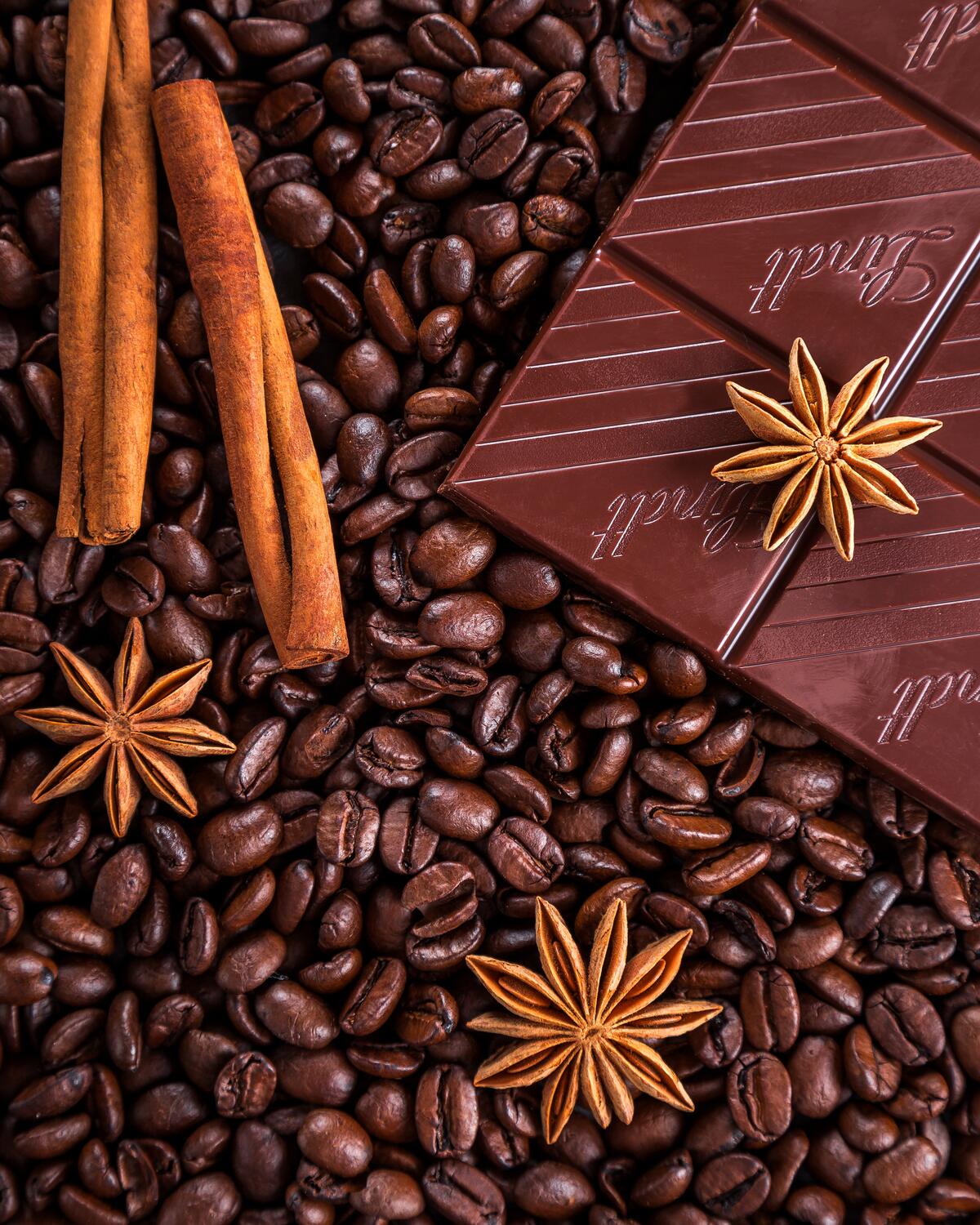 A picture of coffee beans and dark chocolate.