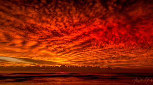 Потрясающее красное небо с перистыми облаками на закате дня