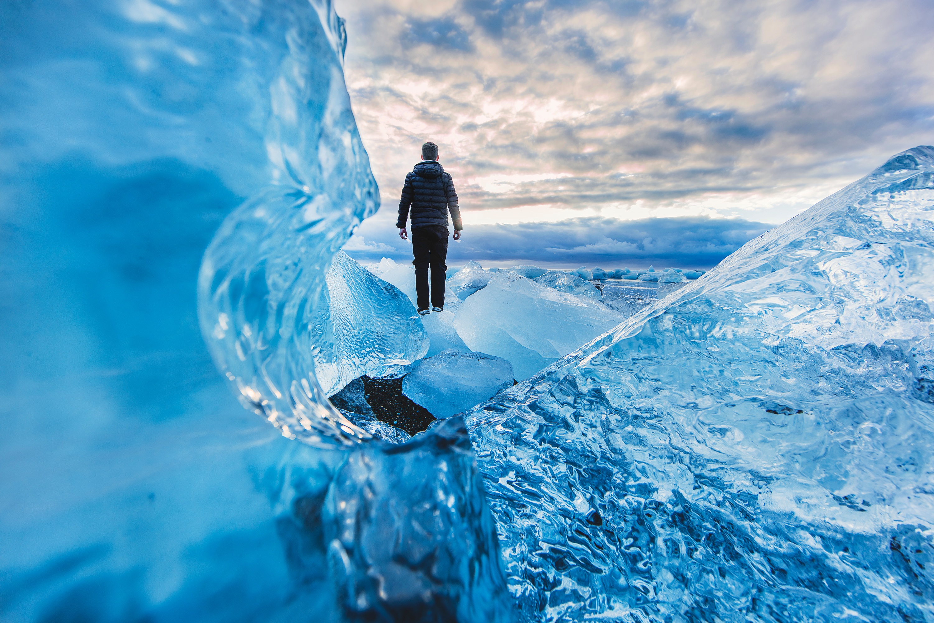 Man stands on a block of ice in the Arctic