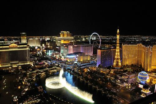 Las Vegas metropolis night city with a beautiful backlit fountain