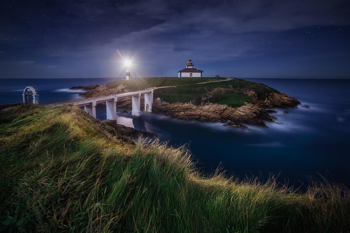 A bridge connects the island to the lighthouse