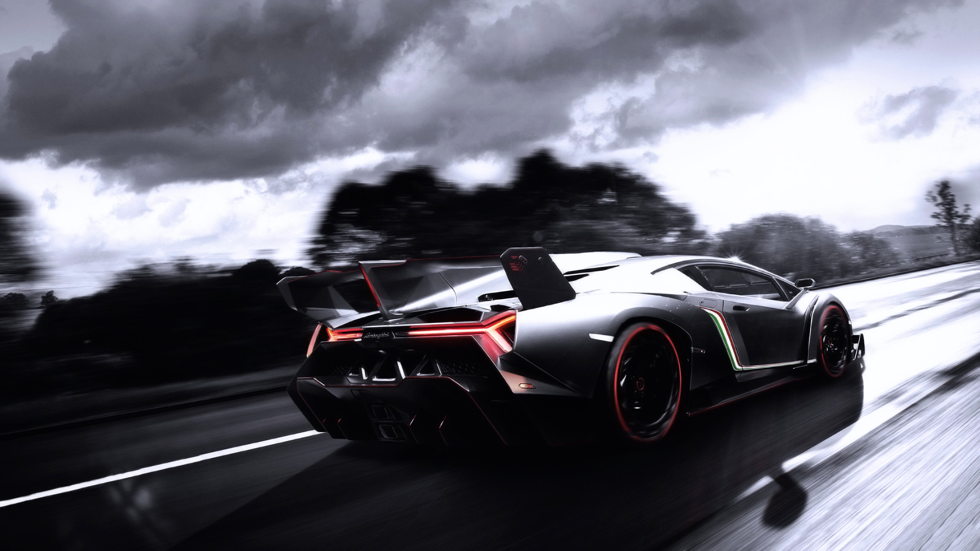 Monochrome photo of lamborghini going at high speed rear view
