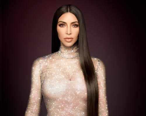 Brunette Kim Kardashian in a glittery dress