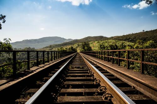 A picture of a railroad on a bridge