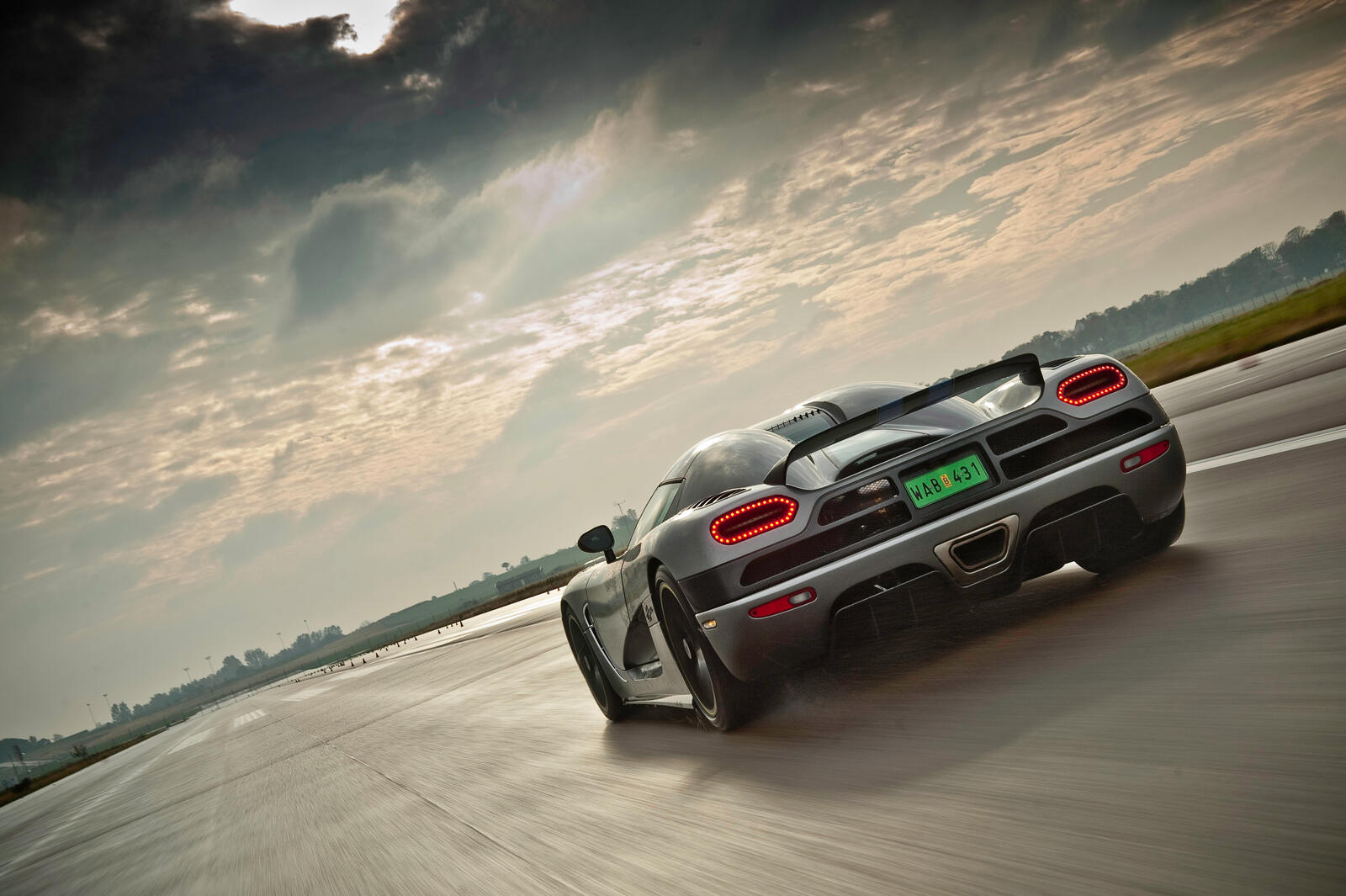 Free photo The Koenigsegg Agera rides at high speed rear view