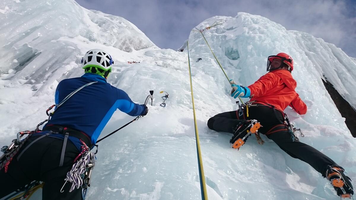 Mountain climbers climb an icy mountain