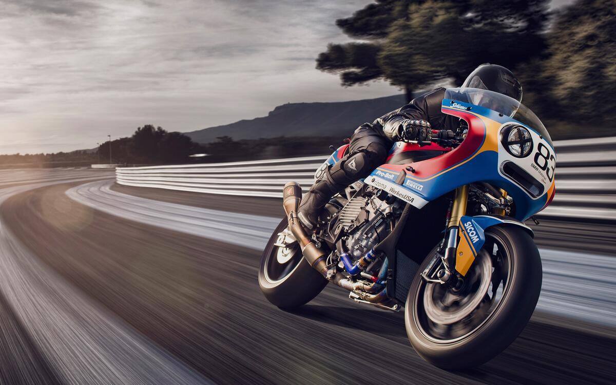 A racer on a BMW S1000 RR is racing down the track