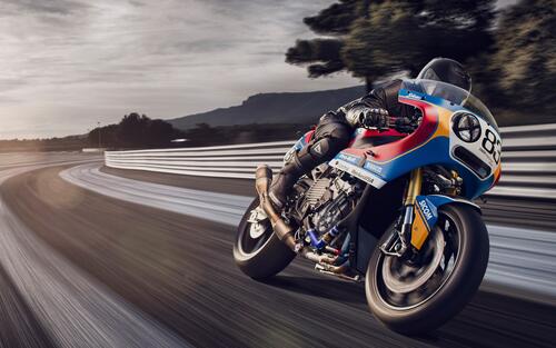 A racer on a BMW S1000 RR is racing down the track