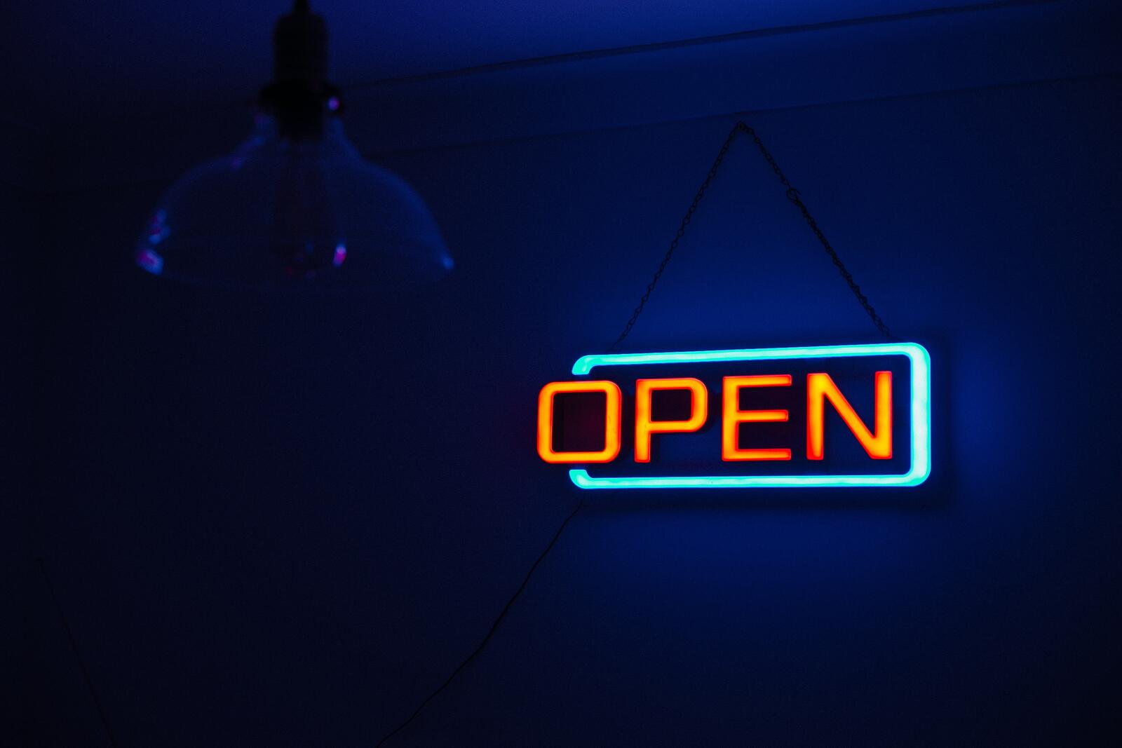 Free photo Neon sign openly on a blue background