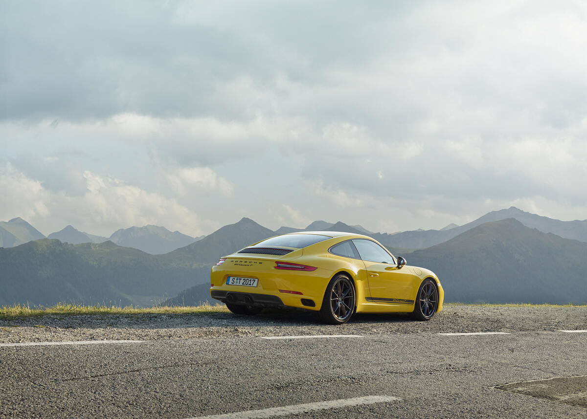 Yellow Porsche 911 standing on the side of the road
