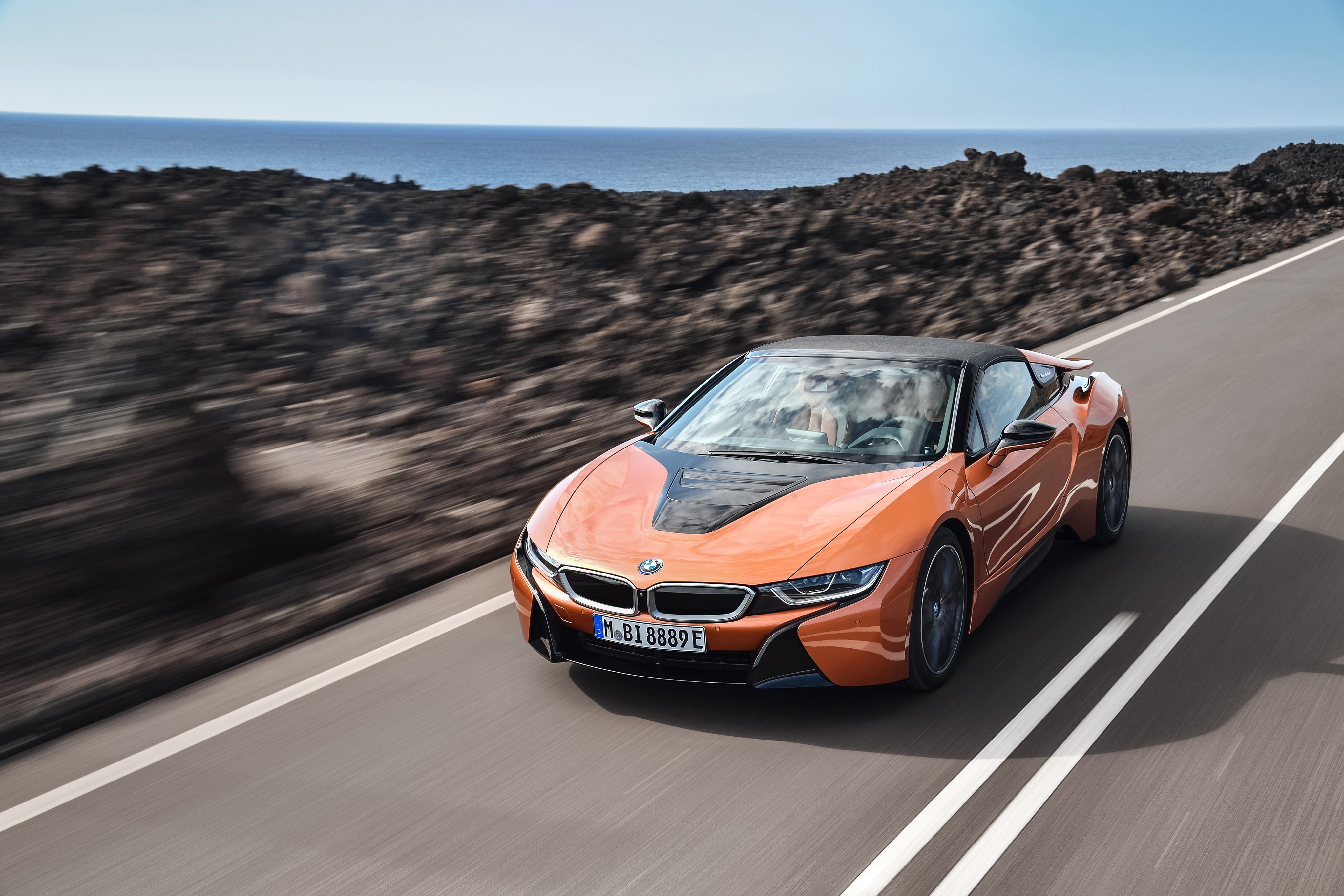 Free photo The 2018 BMW I8 drives on a country road