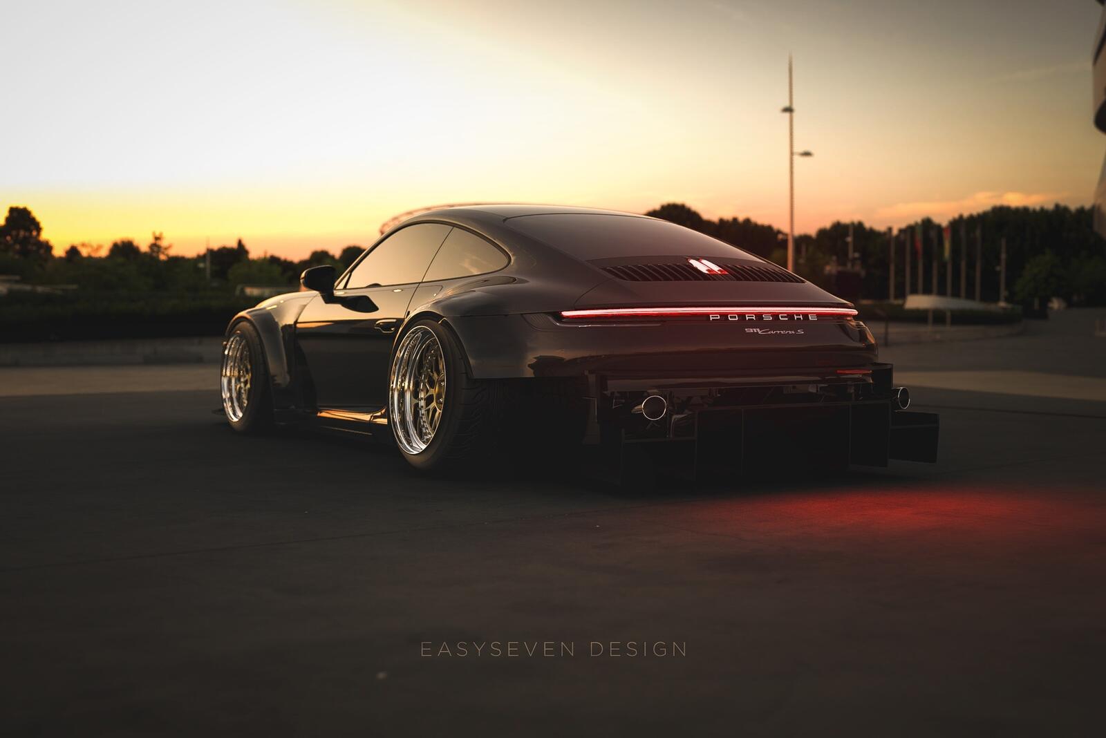 Free photo The 2020 Porsche 911 stands at sunset rear view