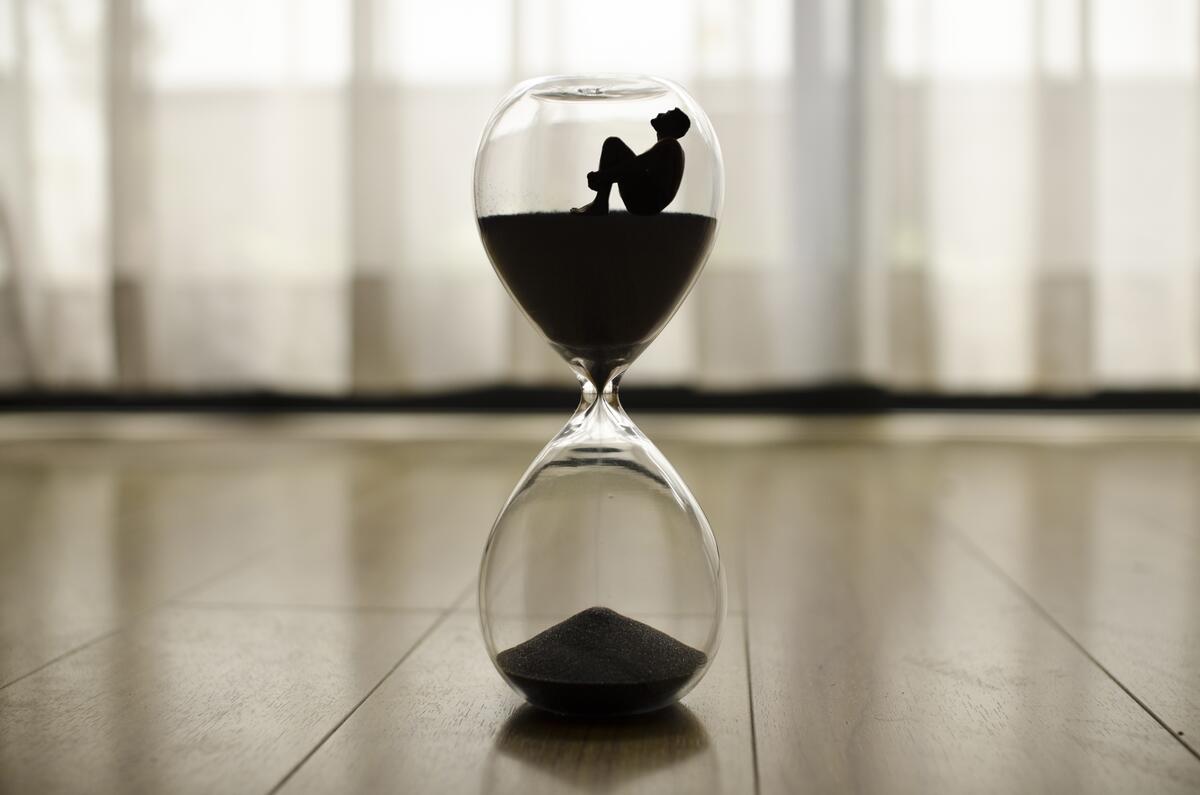 Creative hourglass with a sitting person