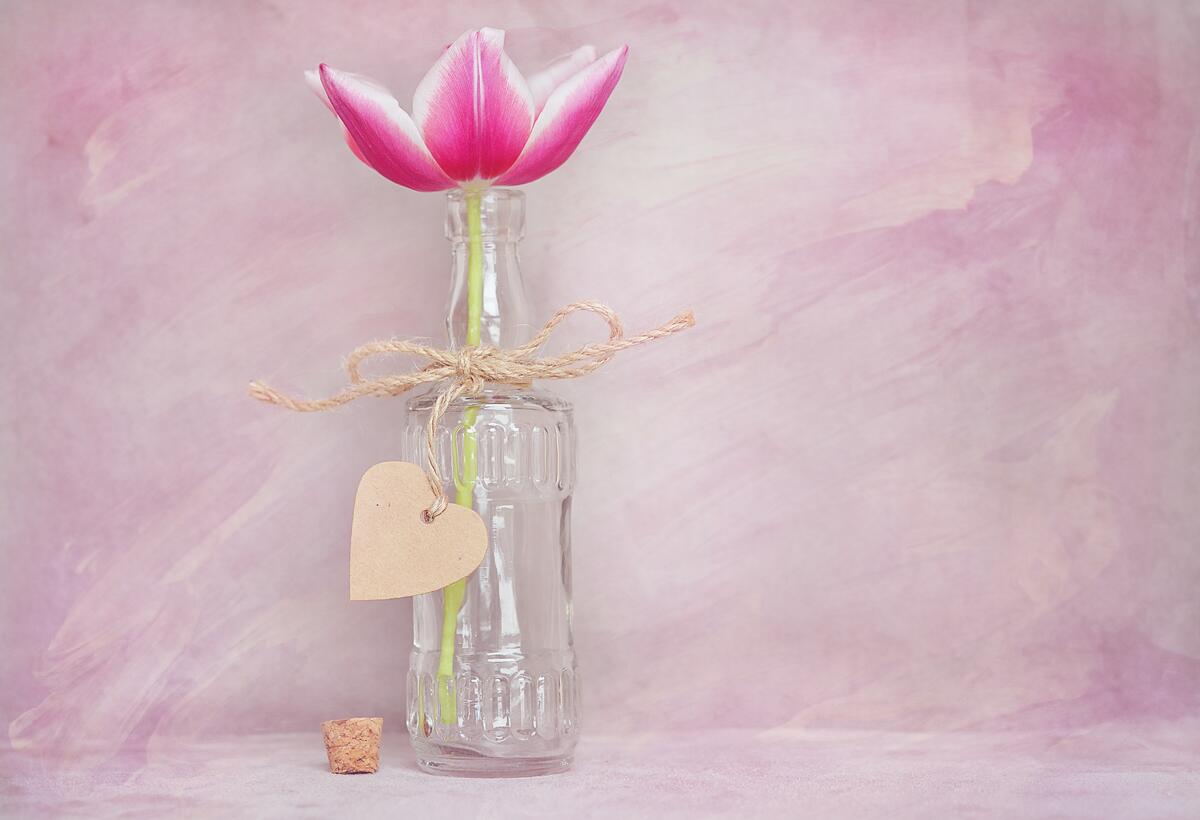 Transparent bottle with pink flower