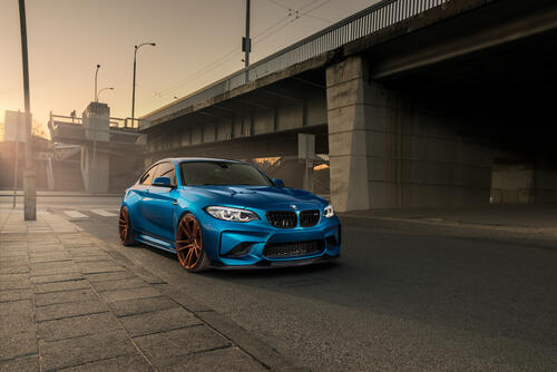 Blue BMW M2 under the bridge