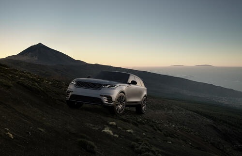 A gray Range Rover Velar at sunset.