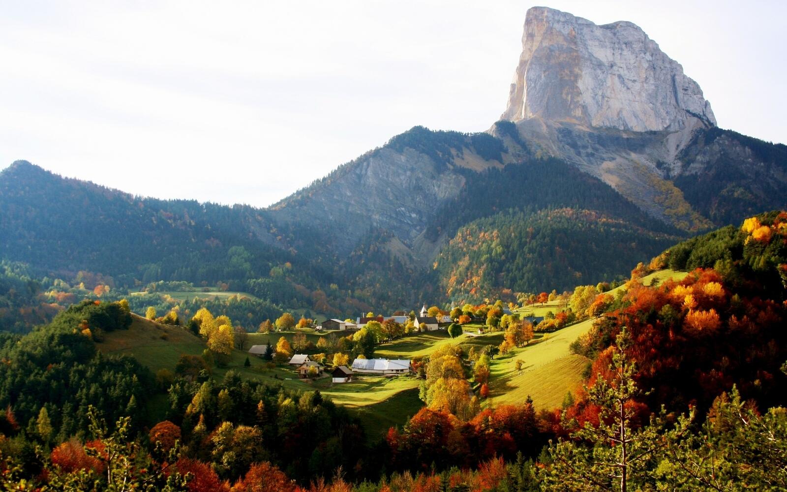 Free photo Autumn village at the foot of the mountain