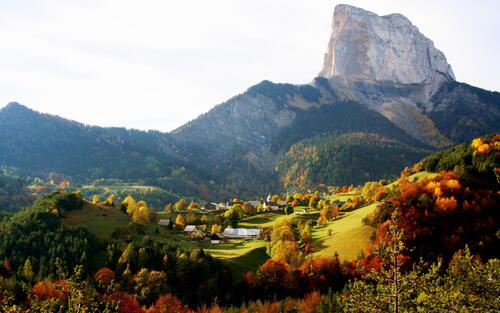 Autumn village at the foot of the mountain